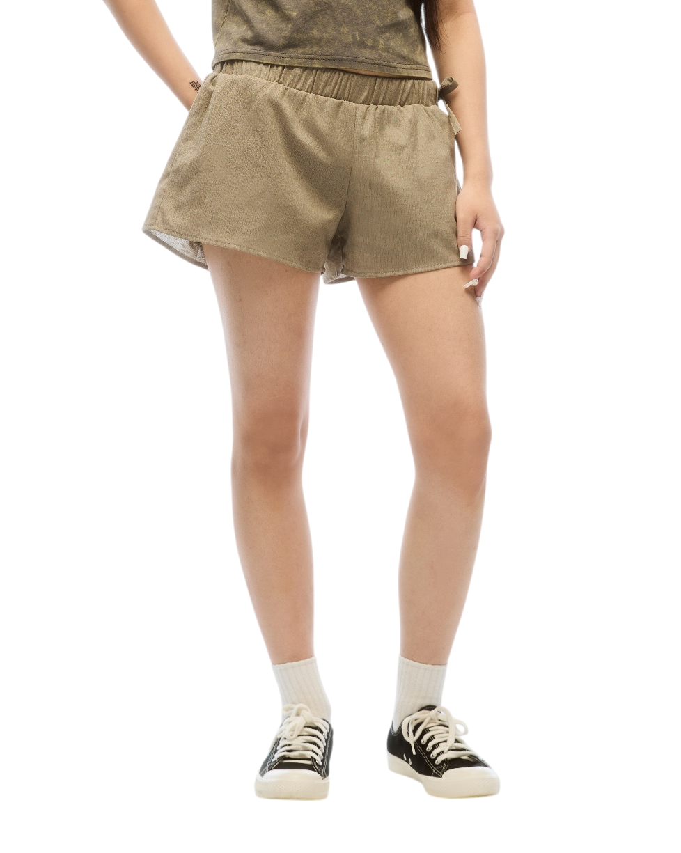 Woman wearing a brown t-shirt and shorts set on a white background