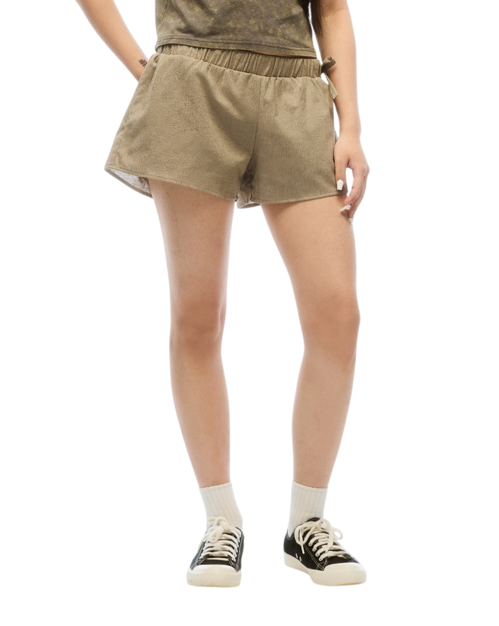 Woman wearing a brown t-shirt and shorts set on a white background